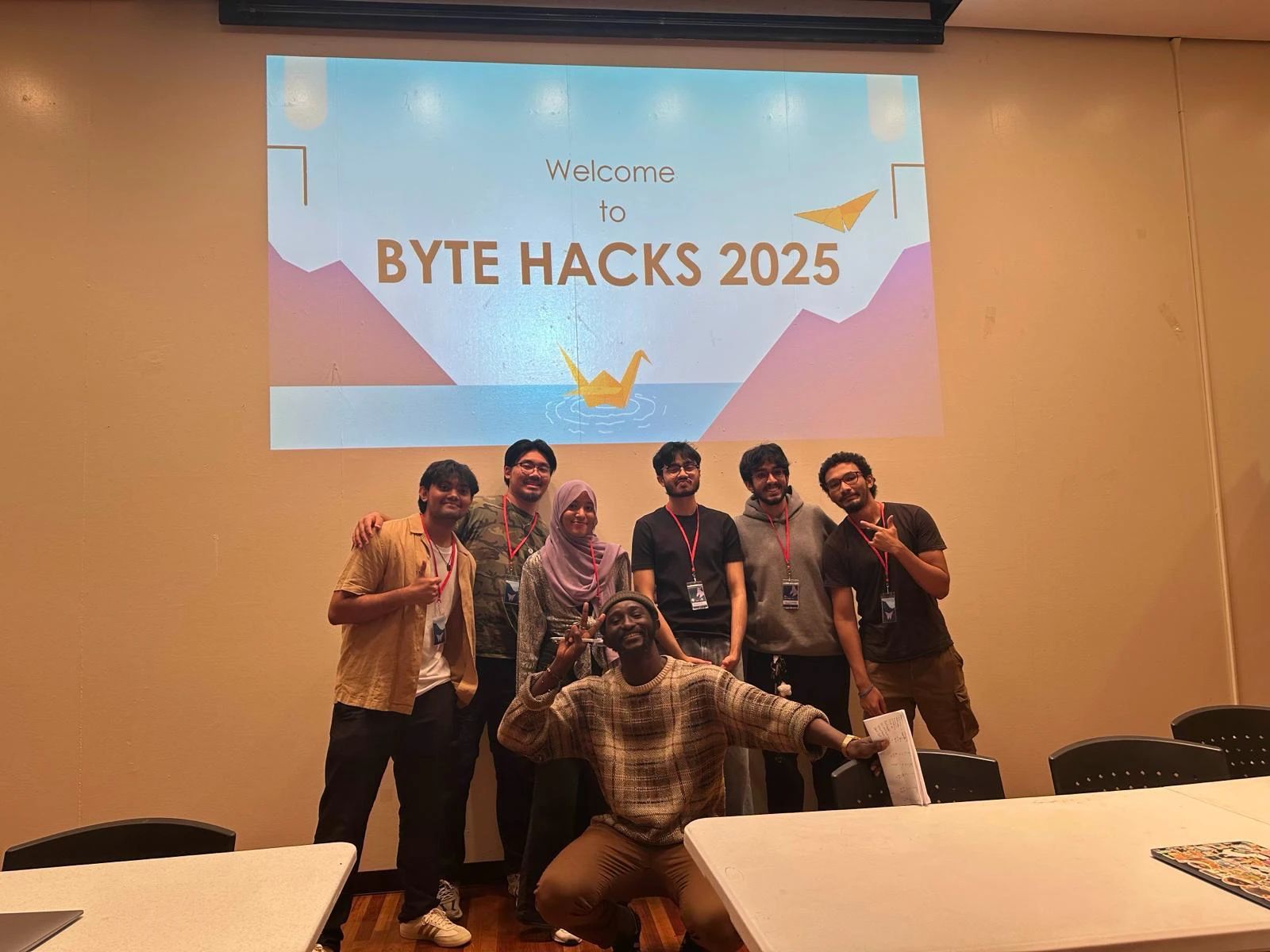 Participants pose in front of the “Welcome to Byte Hacks 2025” screen.