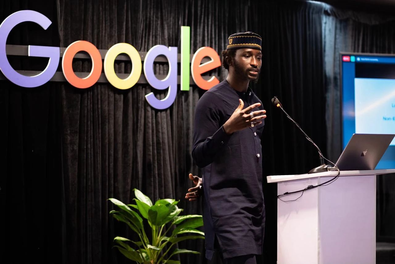Bakary Diarrassouba speaking in front of the Google logo.
